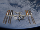 International Space Station Set Against the Background of a Cloud Covered Earth
