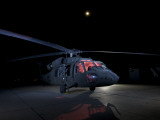 A UH-60 Black Hawk Helicopter Parked on the Flight Line under a Full Moon