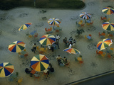 Mosaics and Rainbow-Colored Cafe Umbrellas Decorate a City Sidewalk