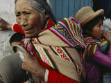 A Woman Removes Her Hat in Respect as a Catholic Procession Passes By
