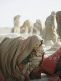 Wrapped Against Wind and Sand  a Kuchi Woman Lifts a Young Child