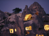 Figures Stand in the Doorways of Ancient Cave Dwellings