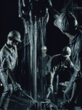 Oilmen Covered in Mud Pull Up a Drill Pipe to Change the Bit