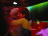 A Couple in a Warm Embrace Dance the Tango