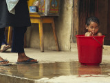 Bhutanese Boy Bathing in a Bucket