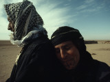 A Sheepherding Bedouin and His Wife Pose for a Portrait
