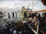 Faithful Residents Reach for a Palanquin Holding a Religious Image