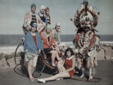 Women Pose in their Bathing Suits Near the Beach Next to a Zulu Man
