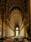Men Pray on Rugs or Read Korans Beneath Limestone Columns and Arches