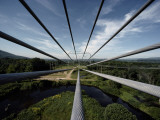 Nine Electric Cables Stretch from a Frame to a Transmission Tower