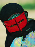 An 18-Year-Old Muslim Woman Wears a Traditional Masks