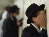 A Young Ultra-Orthodox Jew Covers His Face and Prays at the Wall