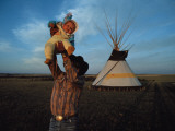 A Blood Indian Man Holds His Baby Aloft
