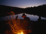 Men and Dogs Sit by a Campfire in New York's Adirondack Mountains