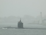 A Submarine Passes New London Harbor Light in the Fog