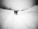 Black and White Image of Two Climbers Ascending Steep Snowfield in Wa