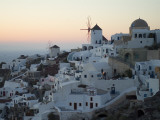 Stuccoed Houses and Windmills on a Hillside at Twilight