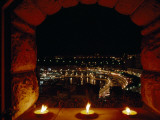 A Night View of Monaco over a Ledge with Candles