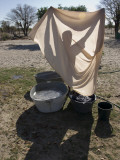 A Woman Washes Laundry by Hand and Dries it in the Sun