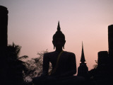 A Silhouette of a Buddha Statue at Sunset