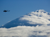 Tourists Fly over a Cloud-Covered Peak in Kronotsky Nature Reserve