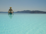 A Woman at an Infinity Pool Overlooking the Aegean Sea