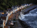 Waves Crash Along the Shoreline in Pennan at Twilight