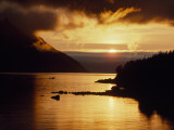 Cloud-Filtered Sunset Silhouettes a Boat on the Sheltered Waters of Bonne Bay
