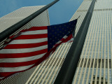 Skyward View of an American Flag Waving in Front of Skyscrapers