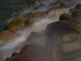 Steaming Water Flows over Rocks Stained by Algae and Bacteria
