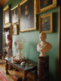 Framed Pictures and Sculpture Adorn a Green Room in Balfour Castle