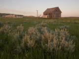 An Abandoned House Sits Near White Butte in the Grasslands
