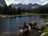 A Guide Leads a Pack String across the North Popo Agie River  Below Cirque of the Towers Peaks