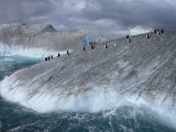 Ash from Mt Belinda Stains an Iceberg Habitated with Penguins