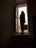 A Woman Hauls Government Supplied Water from the Ground Tank