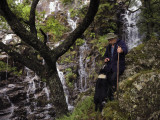 A Shepherd Speaks to His Dog by a Waterfall
