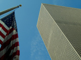 Skyward View of an American Flag in Front of a  Skyscraper