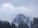 Half Dome Stands Amid the Clouds in Yosemite Valley in Winter