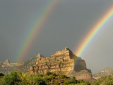 A Pair of Rainbows after a Storm over a Rocky Outcrop
