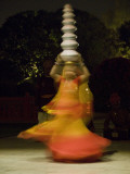Woman Balancing Bowls on Head During a Performance at a Luxury Hotel