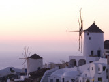 Stuccoed Houses and Windmills on a Hillside at Twilight