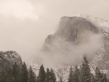 Half Dome Stands Amid the Clouds in Yosemite Valley in Winter