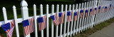 American Flags Hanging on a Picket Fence