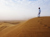 Man Standing on Sand Dune Looking Out on Arabian Desert