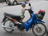Young Motorcyclist with Goggles on Stationary Motorcycle