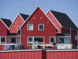 Woman Drying Laundry on Red House