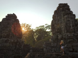 Female Tourist Photographer at Bayon Temple at Sunset