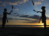 Silhouetted Jugglers on the Beach
