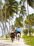 Tourists Horseback Riding Along Beach Trails