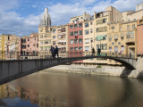 People Crossing Pont D'En Gomez Above Onyar River before Colourful Old Buildings